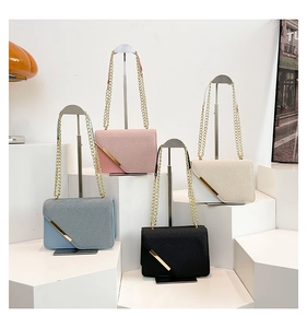 Four colors of stylish diagonal textured flap bags with golden chains on white stands