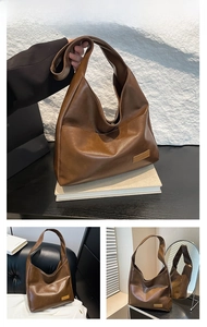 Detail of brown PU leather hobo bag with vintage texture and gold hardware accent