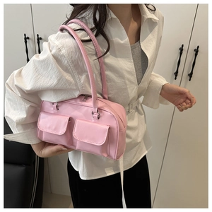 Close-up of pink faux leather shoulder bag with double front flap pockets and long handles