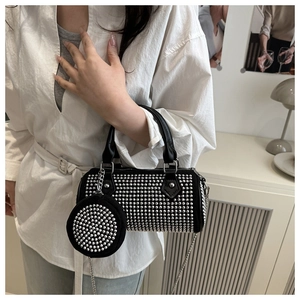 Detail of black boston bag with silver studs and matching round coin purse with chain