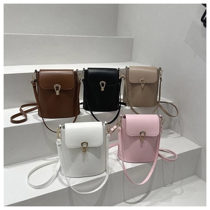 Group shot of colorful mini bucket bags with teardrop metal buckles on white steps