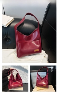 Detailed views of the deep red oiled leather tote bag showing front pocket and handle