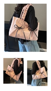 Detail of pink nylon tote bag featuring black bow accents and ruffled shoulder straps