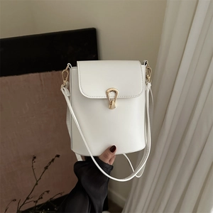 Chic white leather bucket bag with gold metal clasp and adjustable strap, handheld view