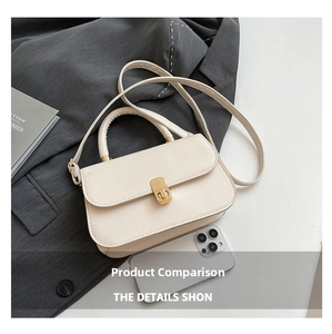 Mini cream underarm bag with gold lock shown next to a smartphone for scale