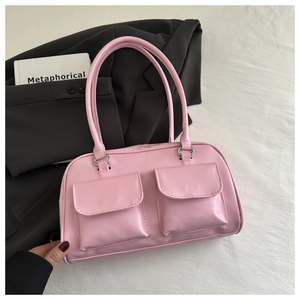 Detail of pink PU leather tote with symmetrical flap pockets and silver metal rings