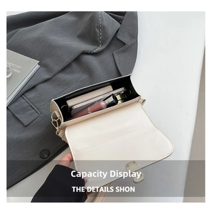 Interior capacity detail of the minimalist cream-colored crossbody bag showing storage space