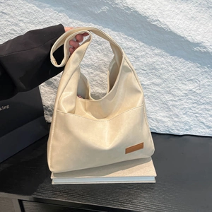 Minimalist cream white soft leather hobo tote bag with a spacious interior design