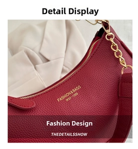 Macro detail of red litchi texture leather underarm bag with gold metal chain