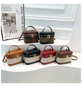 Detailed macro view of retro box-style handbags in diverse canvas and leopard patchwork designs