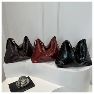 Three colors of glossy oil wax leather tote bags displayed in brown, red, and black