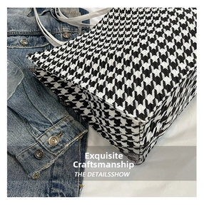Close-up of houndstooth tote bag showing precise stitching and woven fabric detail