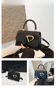 Detailed view of the black glitter box bag with gold metal D-ring buckle and handle