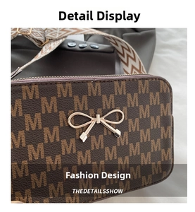 Detailed close-up of brown monogram pattern bag with a golden bow and woven strap