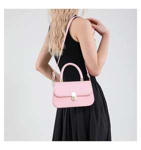 Detailed view of the pink leather mini square bag with golden hardware and top handle