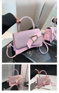 Close-up of pink handbag featuring shiny sequins and a gold D-ring buckle detail