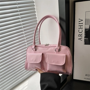 Pink minimalist underarm tote bag with dual front flap pockets and slim shoulder straps