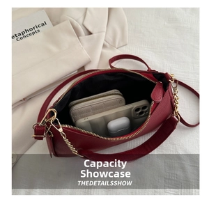 Detail view of the spacious inner compartment of the burgundy pebbled leather handbag