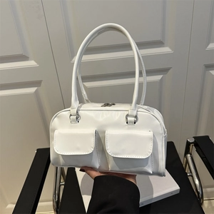 Minimalist white faux leather underarm bag with double front pockets and silver hardware