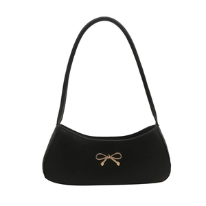 Chic black baguette underarm bag with a golden metal bow buckle for a minimalist look