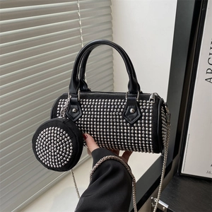 Fashionable black cylinder handbag with silver studs and small round pouch charm