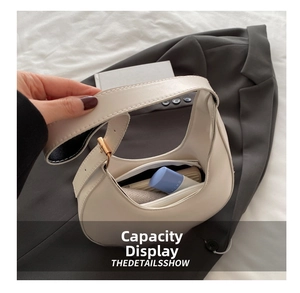 Detail showing the inner zipper pocket and capacity of the white crescent bag