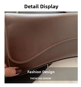 Close-up of fine stitching and smooth brown leather texture on a stylish square bag