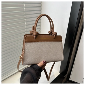Detail of canvas mini tote bag with brown leather trim and FASHION BAG logo