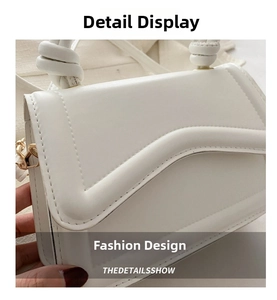 Detail of white leather handbag featuring wavy quilted flap and woven knotted handle