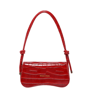 Chic red crocodile pattern patent leather shoulder bag with gold logo on white background