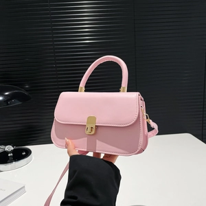 Pink leather saddle bag with gold metal buckle and top handle for elegant daily commute