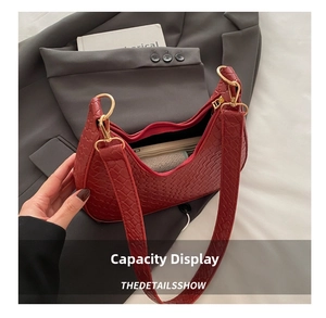 Detail showing the internal storage capacity of the dark red woven hobo shoulder bag