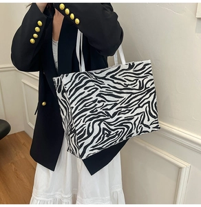 Detail of zebra pattern wool tote bag featuring a high-capacity design for women commute