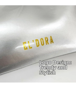 Close-up of metallic silver finish with gold EL'DORA logo on a chic baguette bag