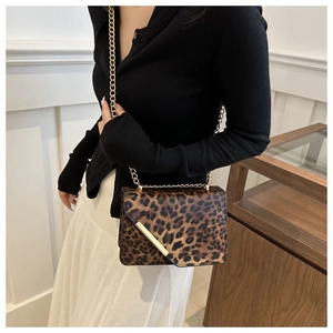 Détail du sac bandoulière léopard avec chaîne dorée et finitions métalliques élégantes