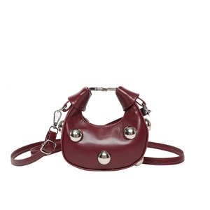 Burgundy moon-shaped handbag with silver metal studs and detachable shoulder strap