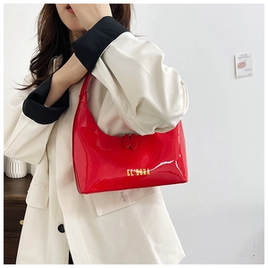 Detail of red patent leather shoulder bag featuring EL'DORA lettering and dual zippers