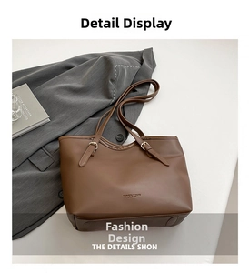 Close-up of brown leather tote bag with adjustable straps and embossed fashion text