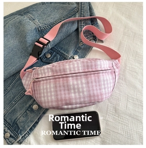 Detail of checkered fanny pack in pink and purple on denim with phone size reference