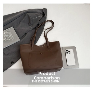 Deep brown tote bag showing large capacity with laptop and daily essentials