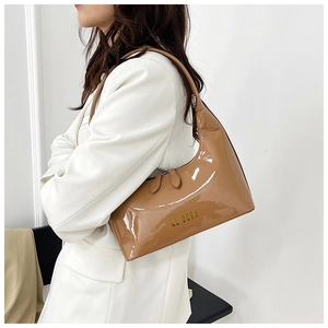 Glossy caramel patent leather detail on hobo bag with gold EL' DORA lettering
