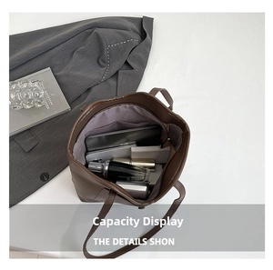Top view of large brown tote bag showing spacious interior with tablet and gadgets
