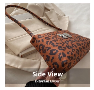 Detail shot of leopard print shoulder bag featuring a decorative silver metallic bow