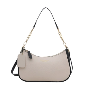 Minimalist beige crescent shoulder bag with black trim and gold chain strap