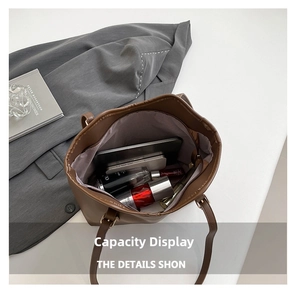 Internal view of large brown leather tote showing space for tablet and cosmetics