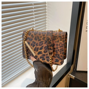 Detail of leopard print flap bag with gold metal trim and stylish chain strap