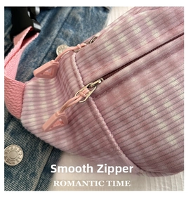 Detail of pink corduroy waist bag showing smooth zipper and soft checkered fabric texture