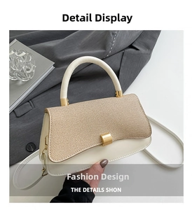 Detail of elegant cream leather and straw woven crossbody bag with gold hardware