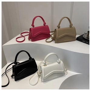 Detailed view of fashionable small square bags in four colors with knotted top handles
