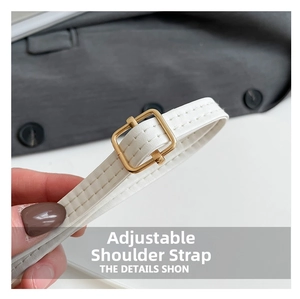Detail of adjustable white leather shoulder strap with luxury square gold buckle